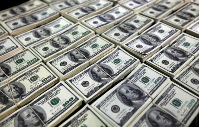 Police officers display counterfeit U.S. dollar bills during a news conference in Lima